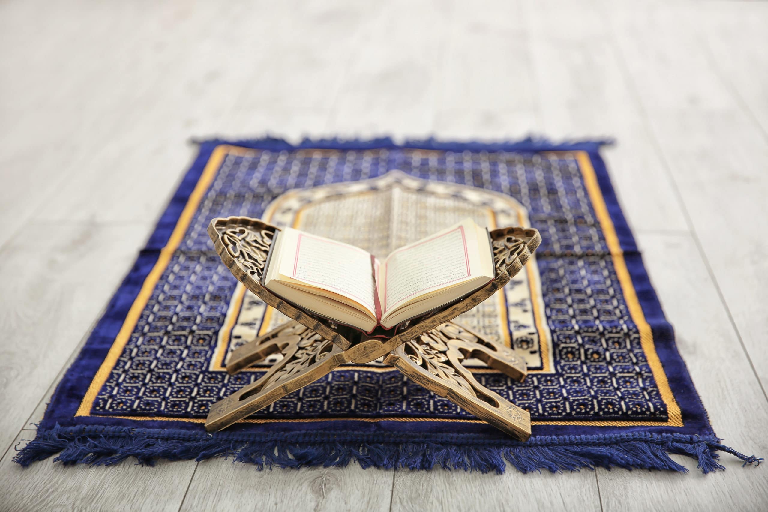 Opened,Quran,On,Muslim,Prayer,Mat,Indoors